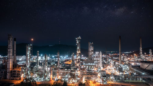 Oil and gas refinery plant or petrochemical industry at night sky and milky way background