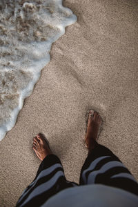 Low section of man on sand