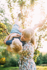 Side view of mother and daughter playing in park