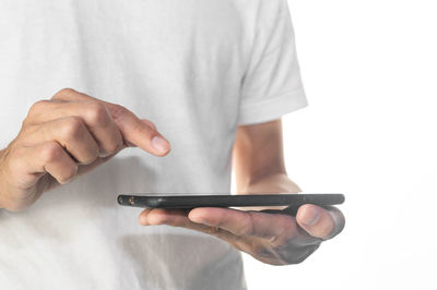 Midsection of man using smart phone against white background