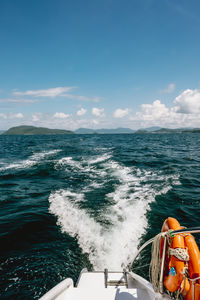 Boat sailing in sea against sky