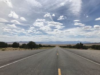 Empty road along countryside landscape