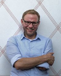 Portrait of smiling man against wall