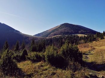 Scenic view of mountains against clear blue sky