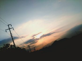 Low angle view of silhouette trees against sky at sunset