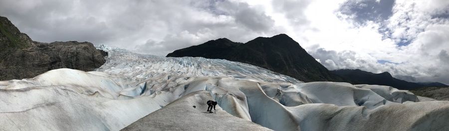 Panoramic view of mountains against cloudy sky