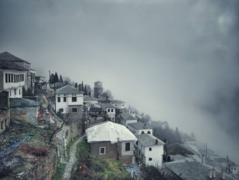 High angle view of buildings in town against sky