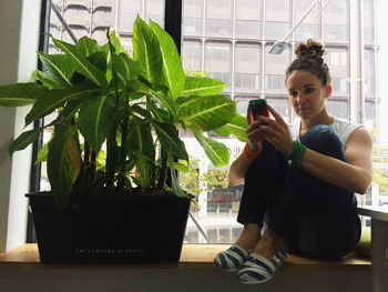 Rear view of woman sitting on bench