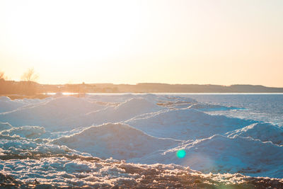 Ice dunes in petoskey michigan during the winter at sunset