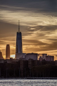 View of cityscape against cloudy sky