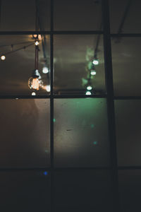 Close-up of illuminated lights on glass window