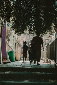 Rear view of people walking on street