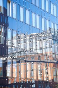 Low angle view of modern building against sky in city