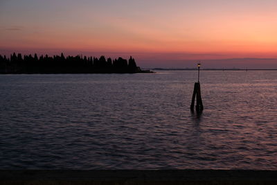 Scenic view of sea against orange sky