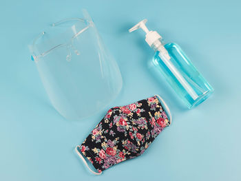 High angle view of bottles on table against white background