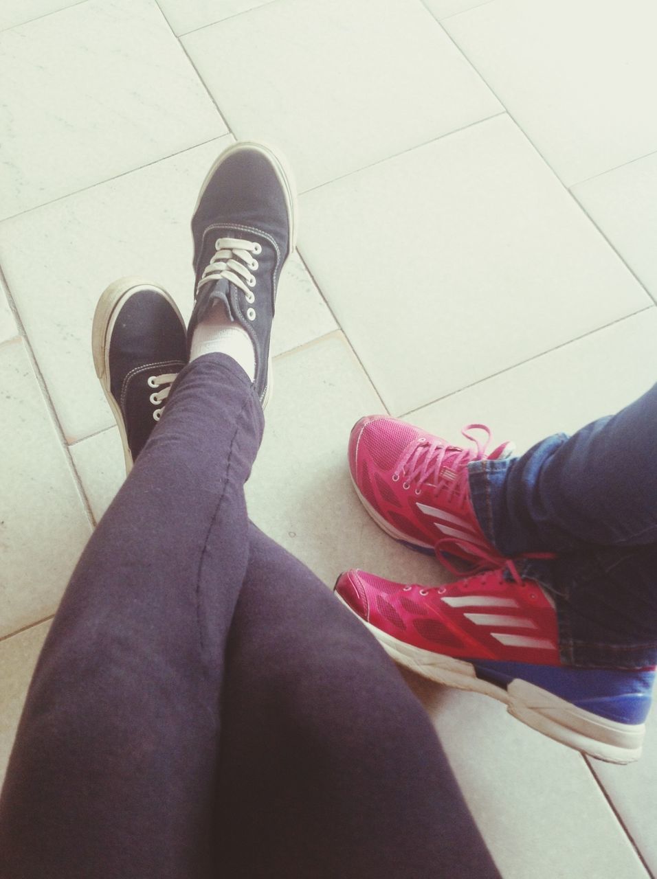 low section, person, shoe, personal perspective, human foot, jeans, footwear, lifestyles, indoors, high angle view, standing, men, part of, tiled floor, sitting, legs crossed at ankle