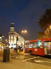 Cars on illuminated city at night