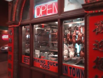 Reflection of illuminated text on glass window