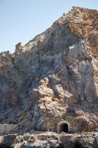 Low angle view of rock formation against sky