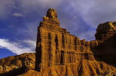 Low angle view of rock formation against sky