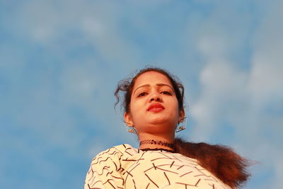 Portrait of a teenage girl against sky