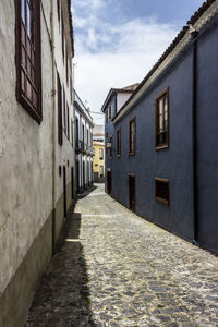 Empty alley amidst buildings in town