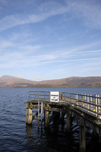 Pier over lake against sky