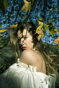 Midsection of woman with plants in park