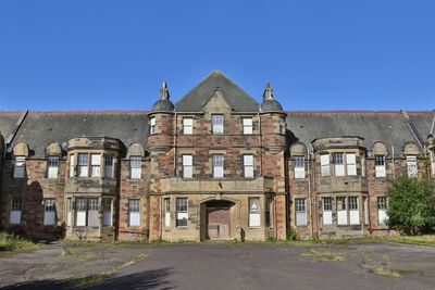 Exterior of old building against clear blue sky