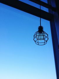 Low angle view of electric light against clear blue sky