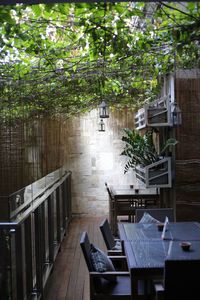 Empty chairs and tables against building