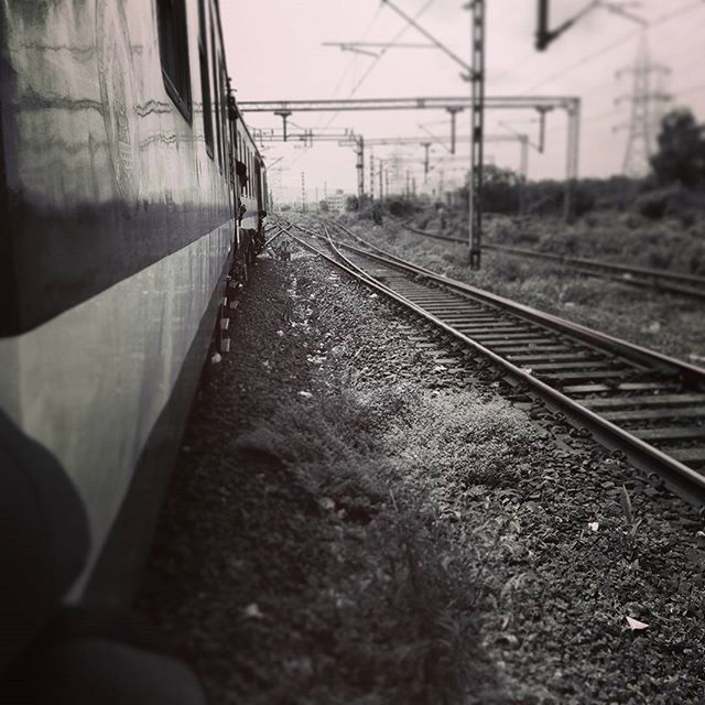 railroad track, rail transportation, transportation, public transportation, the way forward, diminishing perspective, built structure, architecture, railway track, mode of transport, train - vehicle, railroad station, railroad station platform, vanishing point, day, travel, surface level, train, building exterior, abandoned