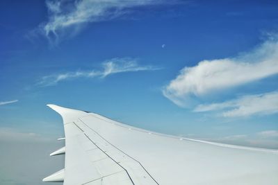 Airplane wing against sky