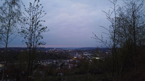 View of cityscape against cloudy sky