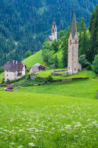 View of temple on field against buildings