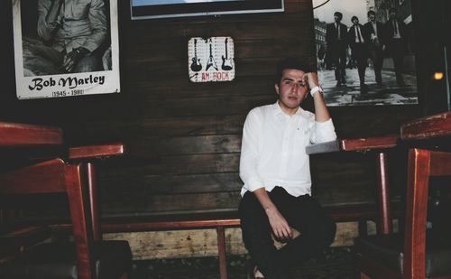 Portrait of young man sitting on chair