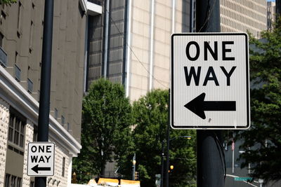 Close-up of road sign against built structure