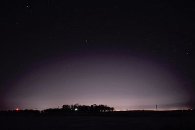 Scenic view of landscape against star field at night