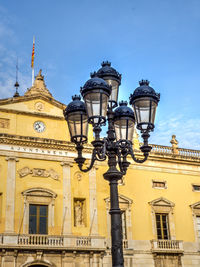 Low angle view of ajuntament de tarragona and street light against sky