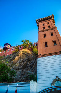 Low angle view of built structure against clear blue sky