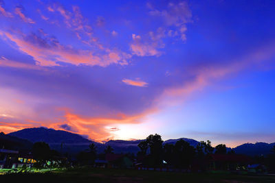 Scenic view of silhouette mountains against sky at sunset