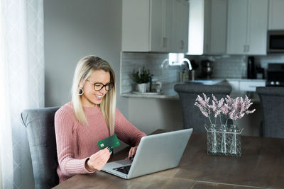 Woman using mobile phone at home