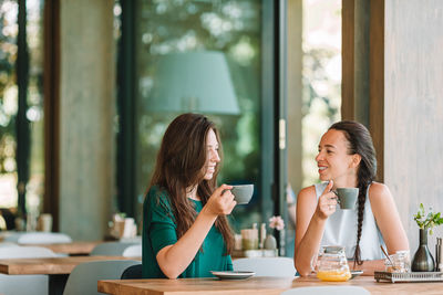 Woman sitting at restaurant table