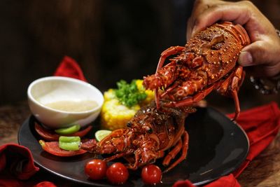 Cropped hand of woman holding food