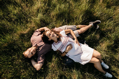 High angle view of couple lying down on field