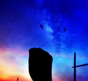 Low angle view of birds flying against blue sky