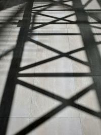 High angle view of shadow on tiled floor