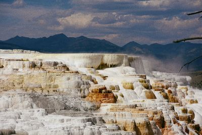 Panoramic view of rocks against cloudy sky