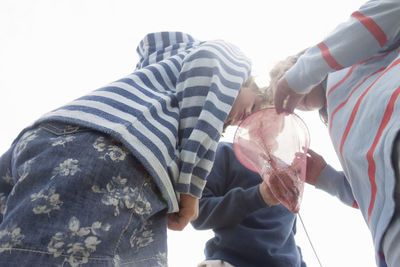 Friends catching crabs in fishing net