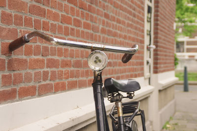 Close-up of bicycle against brick wall